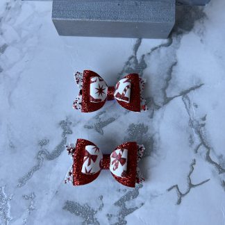 Baby sized white and red glitter backing, red glitter middle layer with christmas theme print on top finished with red middle and lined alligator clasp