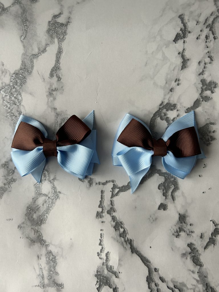 Sky blue and brown double pinch bows on blue backing and clasps