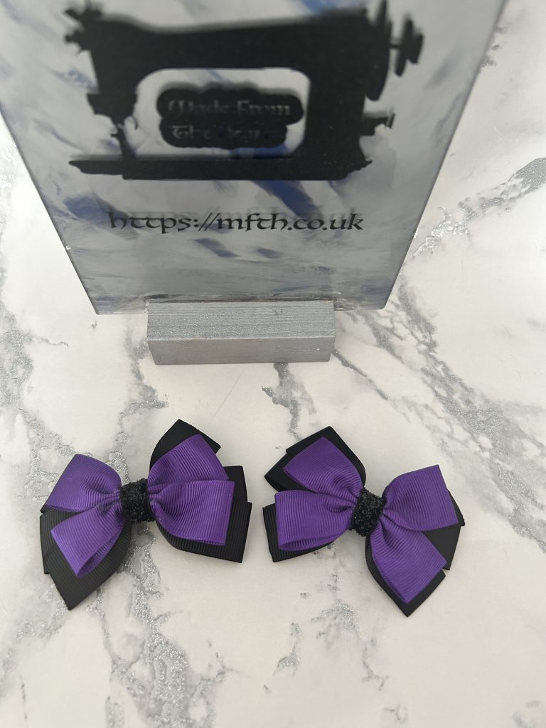 Black backing and cadbury purple double pinch bows on clasps