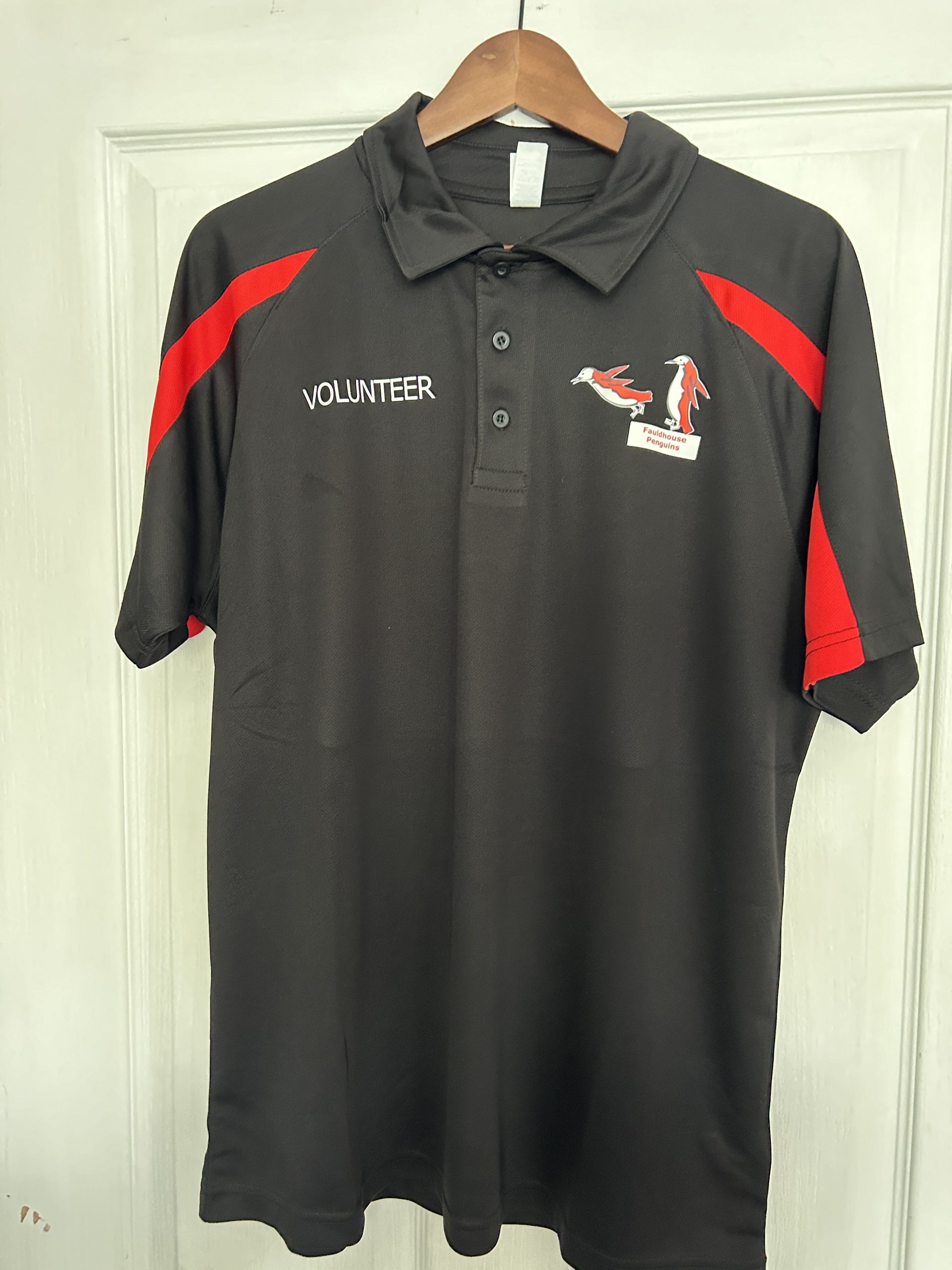 Adult black with red accent volunteer polo for fauldhouse penguins