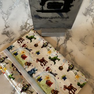 Book cover in fabric with an elasticated band. Print is inspired by everyones favourite toys